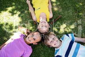 Happy children lying on grass