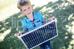 Boy holding a solar panel