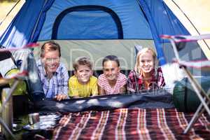 Happy family lying in a tent