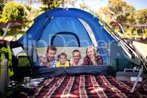 Happy family lying in a tent