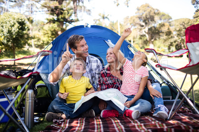 Family sitting in front of a tent