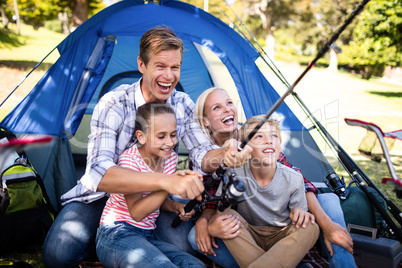 Family fishing outside their tent