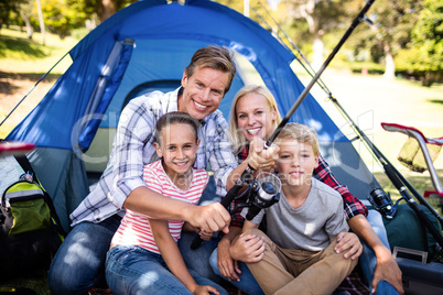 Family fishing outside their tent