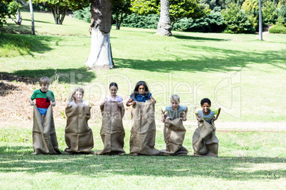 Children having a sack race in park