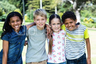 Portrait of happy children standing together in park