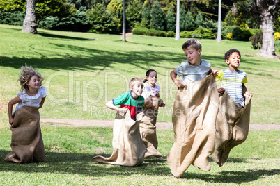 Children having a sack race in park