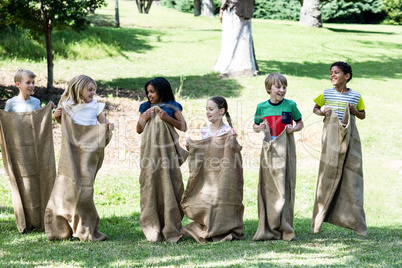 Children having a sack race in park