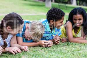 Happy children lying on grass