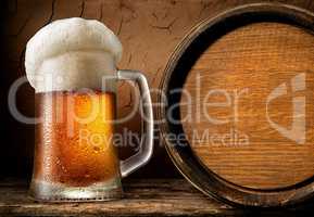 Frothy beer and barrel
