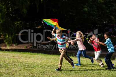 Happy children playing with a kite