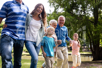 Multi-generation family walking in the park