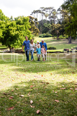 Multi-generation family walking in the park