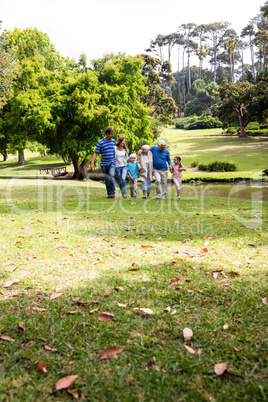 Multi-generation family walking in the park