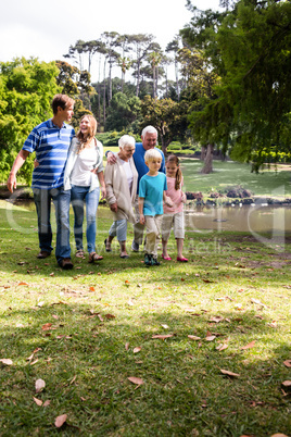 Multi-generation family walking in the park