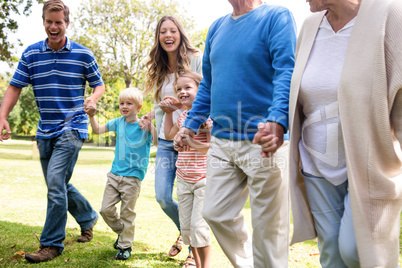 Multi-generation family walking in the park