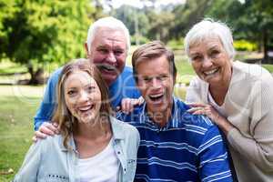 Portrait of happy family sitting together in the park