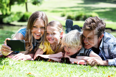 Happy family taking a selfie in the park