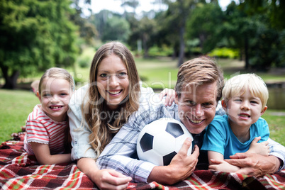 Happy family lying in the park