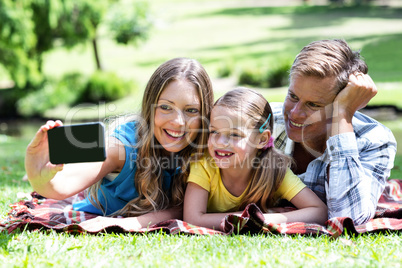 Parents and daughter taking a selfie on mobile phone