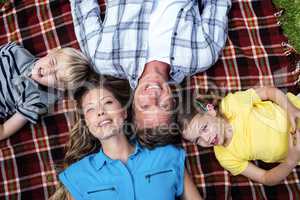 Family lying together in the park