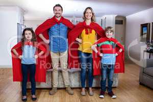 Portrait of a family pretending to be superhero in living room