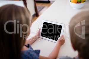Siblings using digital tablet