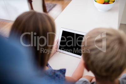 Siblings using digital tablet