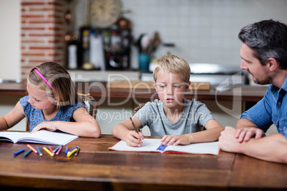 Father helping kids with their homework