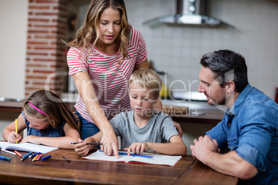 Parents helping the kids with their homework