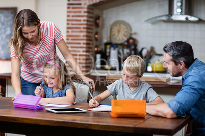 Parents helping the kids with their homework