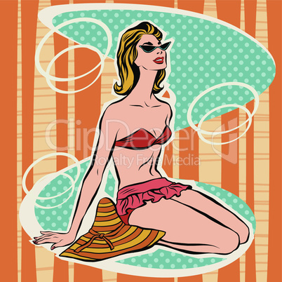 Girl in bikini sitting on beach