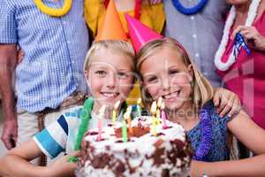 Siblings celebrating birthday party with family