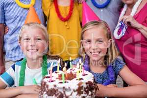 Siblings celebrating birthday party with family