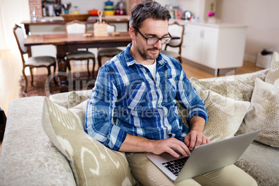 Man using a digital tablet in living room