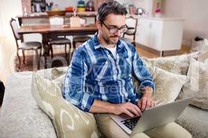 Man using a digital tablet in living room