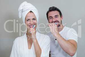 Couple brushing their teeth in the bathroom