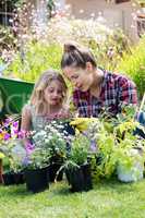 Mother and daughter gardening together in garden