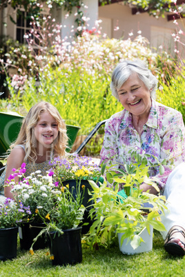 Grandmother and granddaughter gardening together