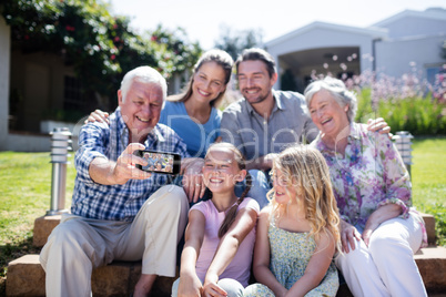 Multi-generation family taking a selfie in the garden