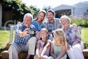 Multi-generation family taking a selfie in the garden