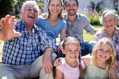 Multi-generation family sitting in the garden