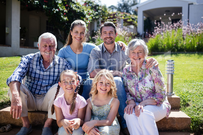 Multi-generation family sitting in the garden