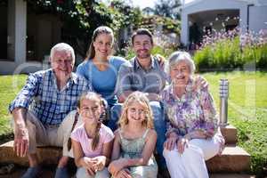 Multi-generation family sitting in the garden