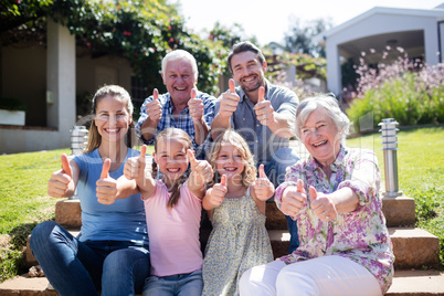 Multi-generation family sitting in the garden