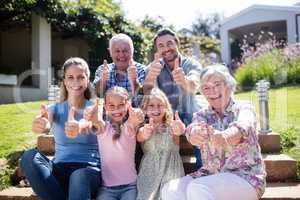 Multi-generation family sitting in the garden