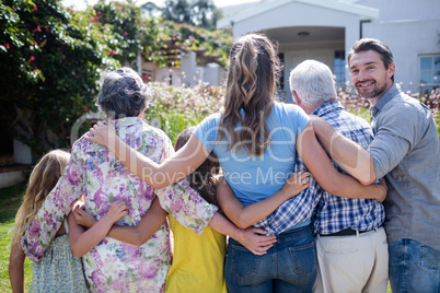 Multi-generation family walking on the garden path