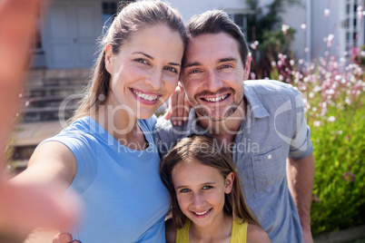 Father and daughter taking a selfie with selfie stick