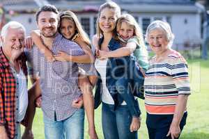 Portrait of multi-generation family standing in garden