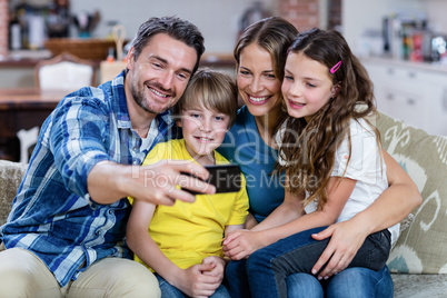 Happy family taking a selfie on mobile phone