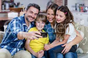 Happy family taking a selfie on mobile phone